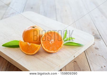 Fresh orangeslice and half of orange on wooden background