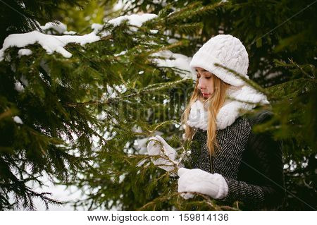 Young Woman In A Forest With Fir And Pine Trees On The Street, Hands Touch The Branches Of Trees, Co