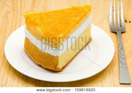 Foi thong cake in a white plate on a wooden board