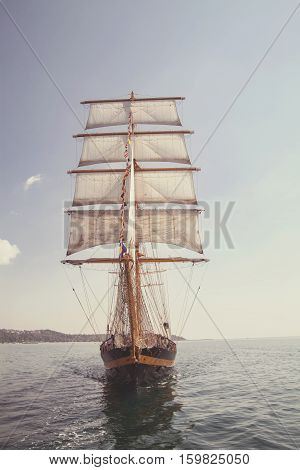 old historical ship (yacht) with white sails sailing in the sea