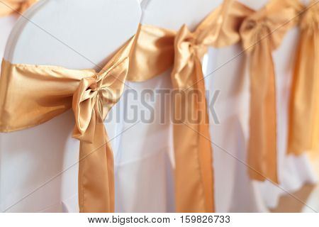 beautiful chairs decoration with ribbon in wedding event hallselective focus.