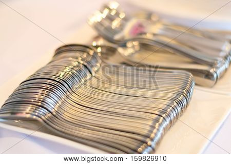 close up many stainless teaspoon in restaurantselective focus.