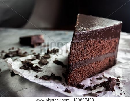 piece of dark chocolate fudge cake selective focus.