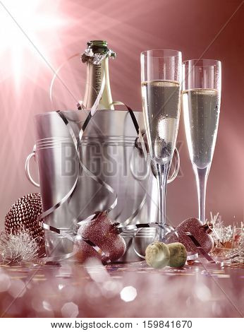 glasses of champagne with bottle in cooler on a red with white background