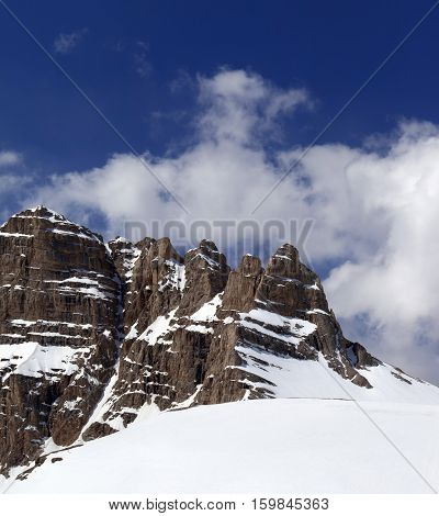 Snowy Rock And Sky With Clouds