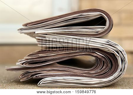 A pile of newspapers on a stairs.