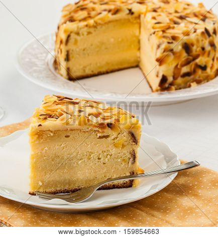 Madame Pompadour cake covered with almonds on a plate.