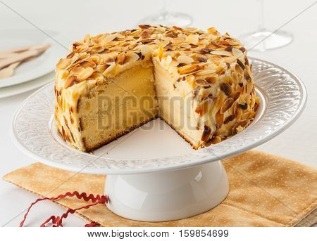 Madame Pompadour cake covered with almonds on a cake stand.