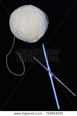 tools for knitting and a ball of yarn