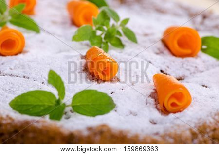 homemade cakes pumpkin cake with powdered sugar mint and decoration of pieces of pumpkin close-up