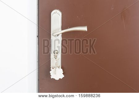 Close Up Of Doorhandle, Key And Door In Home