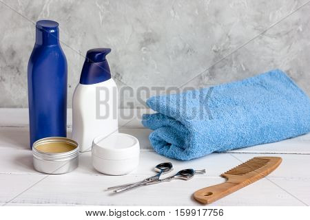 Men's cosmetics for hair care on wooden background close up