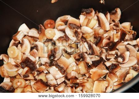 Sliced mushrooms cooking in a slow cooker