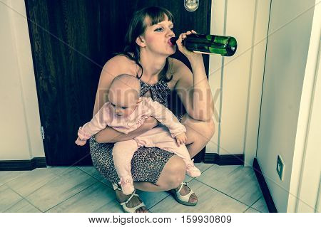 Drunk reckless woman drinking alcohol and holding her baby after return from night party - retro style