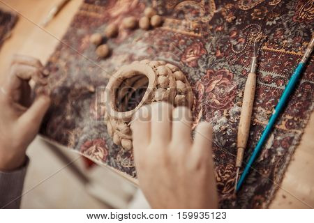 children's hands sculpts clay crafts pottery school
