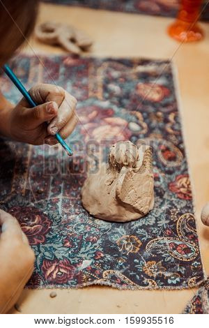children's hands sculpts clay crafts pottery school