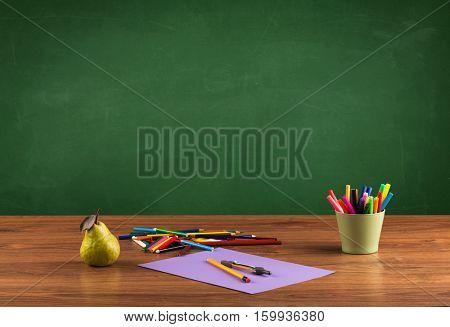 Back to school concepty with clear blackboard background, desk, items
