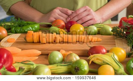 sliced carrot on wood desk near vegetables
