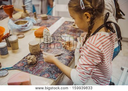 children's hands sculpts clay crafts pottery school