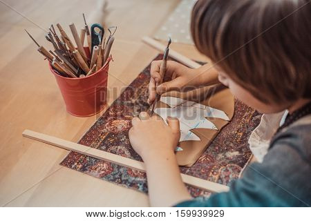 children's hands sculpts clay crafts pottery school