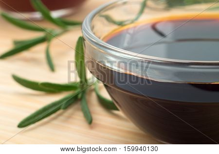 Glass Dish With Soy Sauce And Rosemary Sprigs