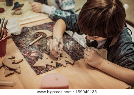 children's hands sculpts clay crafts pottery school