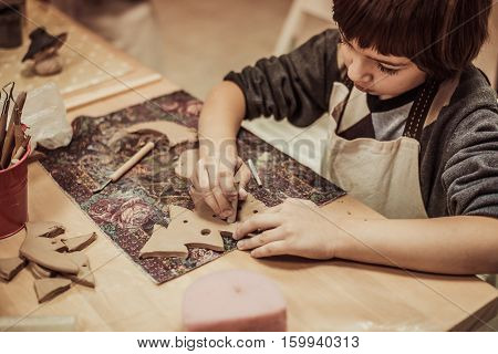 children's hands sculpts clay crafts pottery school