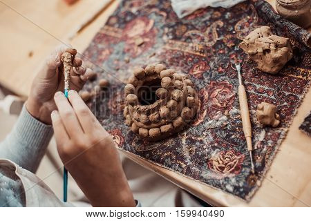 children's hands sculpts clay crafts pottery school