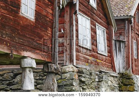 Traditional norwegian wooden red colored cabin houses facades. Otternes Norway