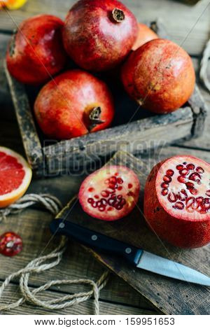 Ripe Pomegranate Fruit On Wooden Vintage Background. Red Juice P