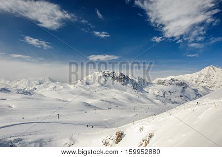 Alpine winter mountain landscape. French Alps covered with snow in sunny day. Val-d'Isere, France