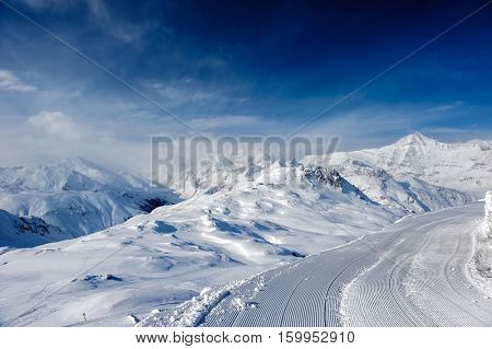 Alpine winter mountain landscape. French Alps covered with snow in sunny day. Val-d'Isere, France