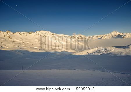 Alpine winter mountain landscape. French Alps covered with snow in sunny day. Val-d'Isere, France