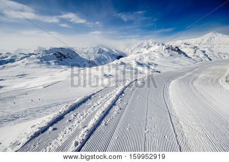 Alpine winter mountain landscape. French Alps covered with snow in sunny day. Val-d'Isere, France