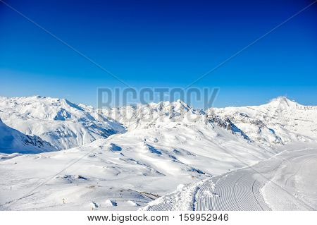 Alpine winter mountain landscape. French Alps covered with snow in sunny day. Val-d'Isere, France