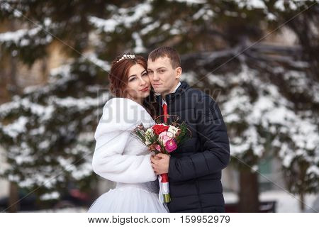 Winter wedding. Young happy bride and groom together. Marriage concept