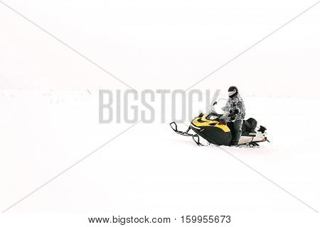 Man on snowmobile. Recreation concept on nature in winter holidays. Winter sports.