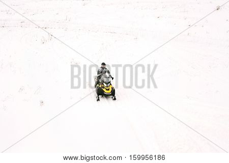 Man on snowmobile. Recreation concept on nature in winter holidays. Winter sports.