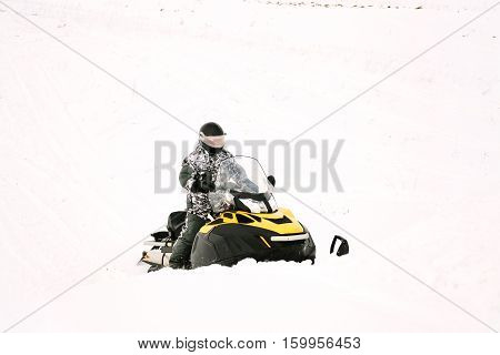 Man on snowmobile. Recreation concept on nature in winter holidays. Winter sports.