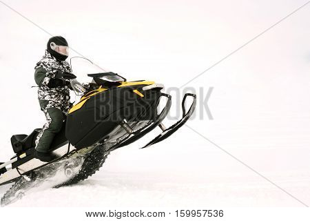 Man on snowmobile. Recreation concept on nature in winter holidays. Winter sports.