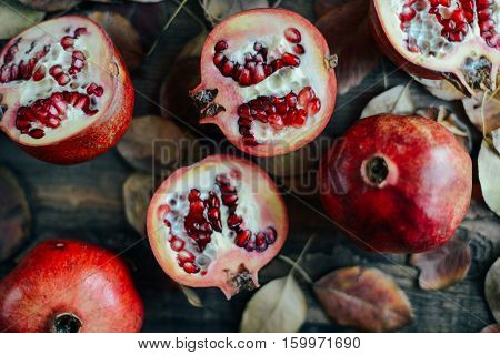 Ripe Pomegranate Fruit On Wooden Vintage Background. Red Juice P
