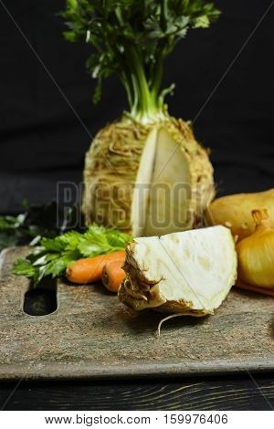 Ingredients for celeriac soup - celery root - celeriac carrots onion potatoes - healthy diet concept