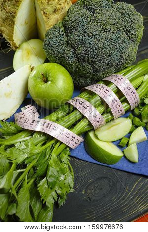 Green vegetables and fruits - celeriac broccoli celery shoots and apples healthy fitness diet concept