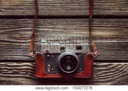 Retro camera on wood table background vintage color tone