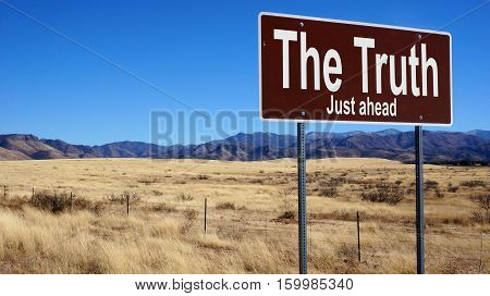 The Truth road sign with blue sky and wilderness