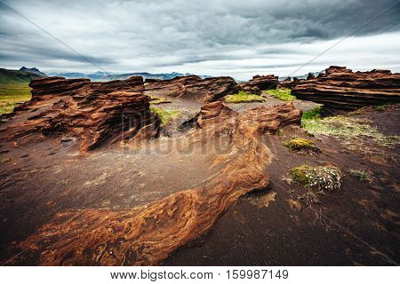 Sandy rocks with by magma formed by winds. Popular tourist attraction. Unusual and gorgeous scene. Location Sudurland, cape Dyrholaey, south coast of Iceland, Europe. Artistic picture. Beauty world.