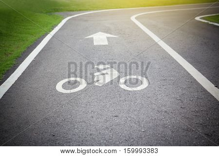 Bicycle symbol on street bike lane in the park.
