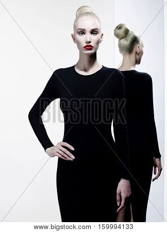 Fashion art studio portrait of elegant woman with red lips. Fashionable lipstick. Professional cosmetic. Portrait of beauty in black dress with big sexy lips. Very beautiful lips. 