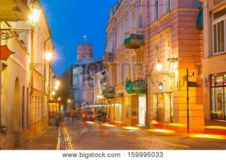 Gediminas Tower or Upper Castle as viewed from Pilies Street with luminous track from the car at night, Old Town of Vilnius, Lithuania, Baltic states.