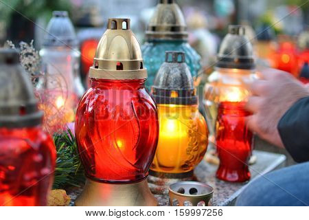 Lighting candles on the grave. All the Saints Day holiday on 1 November in Poland